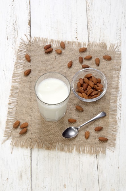 cold almond milk in a glass on jute cold almond milk in a glass on jute
