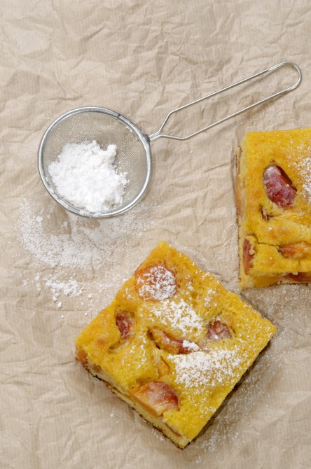 fruit cake with nectarines and powdered sugar on kitchen paper