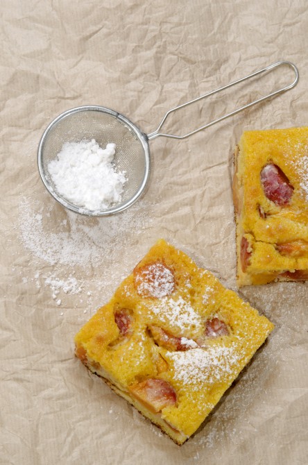 fruit cake with nectarines and powdered sugar on kitchen paper fruit cake with nectarines and powdered sugar on kitchen paper