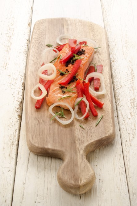 grilled salmon fillet with red paprika, onion rings and rosemary on wooden board grilled salmon fillet with red paprika, onion rings and rosemary on wooden board