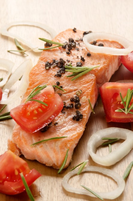 grilled salmon fillet with tomato cube, onion rings and rosemary on wood grilled salmon fillet with tomato cube, onion rings and rosemary on wood