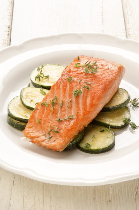 grilled salmon fillet with zucchini and thyme on a white plate grilled salmon fillet with zucchini and thyme on a white plate