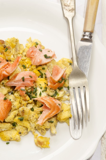 scrambled eggs with salmon and dill on a white plate