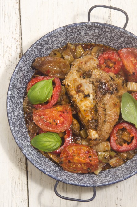 grilled mediterranean chicken fillet with tomato, mushroom, onion, olive oil and basil in a pan