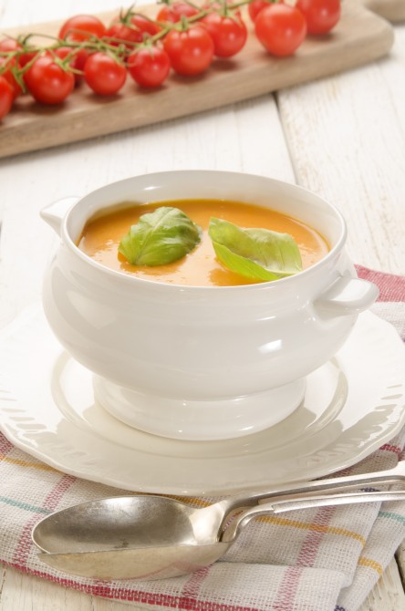 tomato curry soup with basil in a bowl