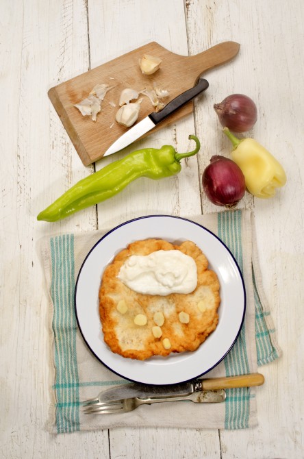 hungarian breakfast with langos, sour cream, garlic, onion and paprika