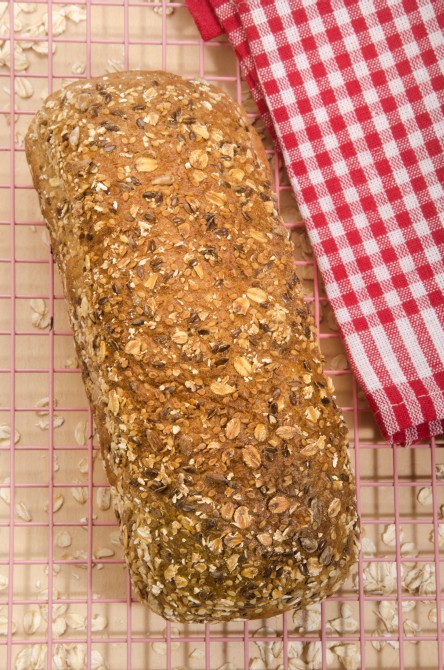 freshly baked whole wheat bread on a pink cooling rack