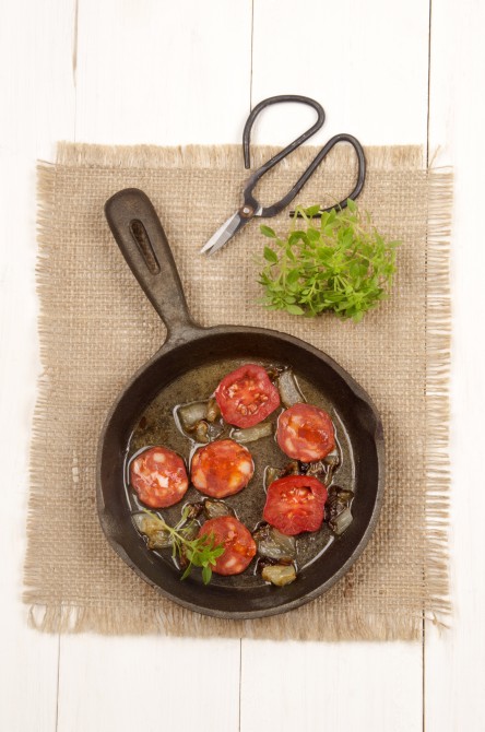 spanish chorizo with tomato, sweet basil and onion in a cast iron pan spanish chorizo with tomato, sweet basil and onion in a cast iron pan