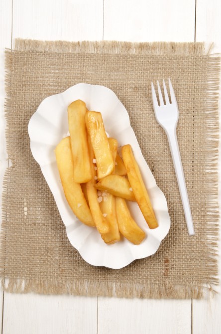 french fries on a white cardboard dish with a plastic fork