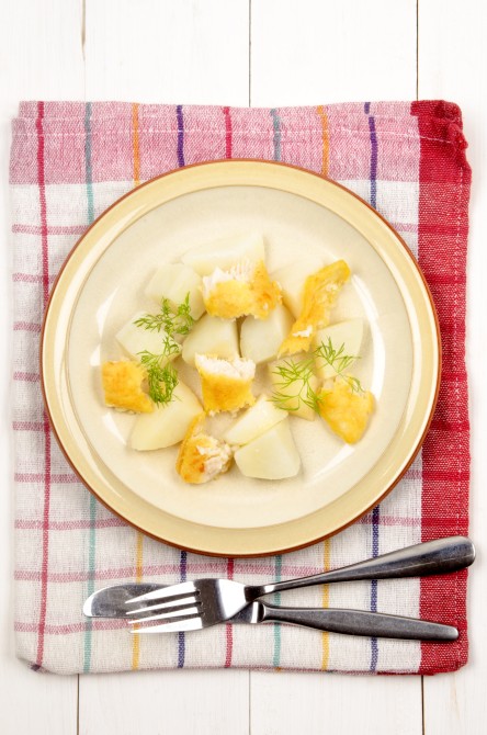 boiled potatoes with smoked cod and dill on a plate