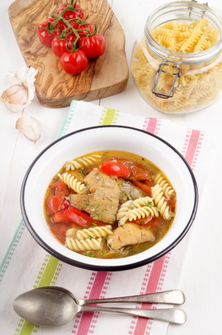 mediterranean fish soup with tomato, red bell pepper, noodle and garlic in a bowl mediterranean fish soup with tomato, red bell pepper, noodle and garlic in a bowl