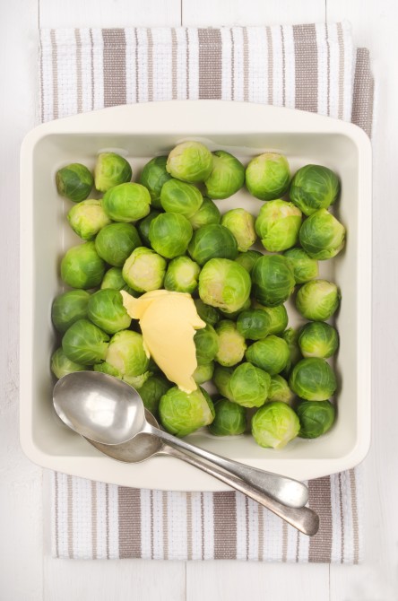 cooked brussels sprouts with butter in a bowl and spoon cooked brussels sprouts with butter in a bowl and spoon