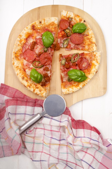 home made spicy meat pizza with basil