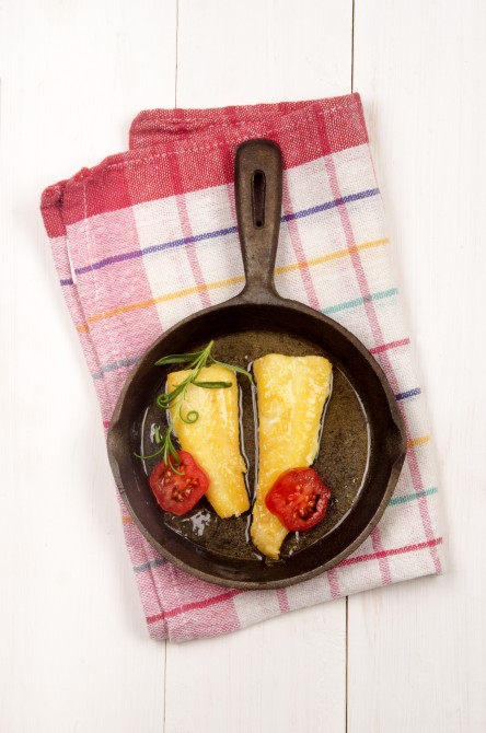 smoked cod with rosemary and tomato in a pan