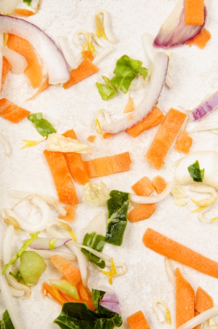 cleaned red onion, red bell pepper, cabbage and carrot on a kitchen worktop