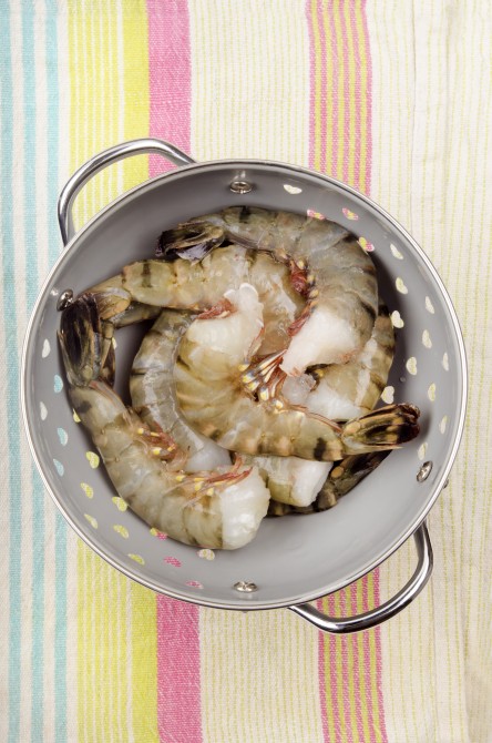 fresh raw king prawns in a colander fresh raw king prawns in a colander