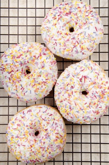 baked donut with colorful sprinkles on a cooling rack