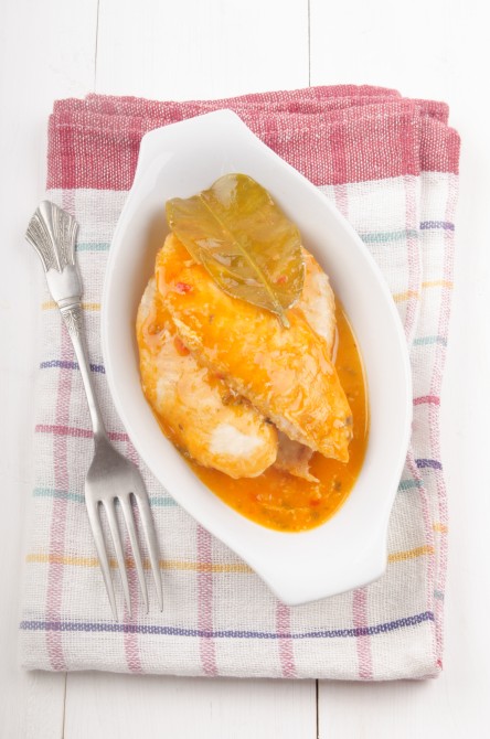basa fish with curry sauce and lime leaf in a bowl basa fish with curry sauce and lime leaf in a bowl