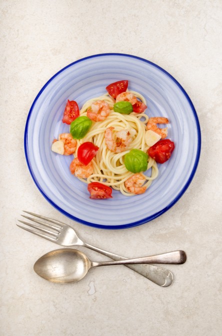 prawn with spaghetti, cherry tomato, basil and garlic on a plate prawn with spaghetti, cherry tomato, basil and garlic on a plate