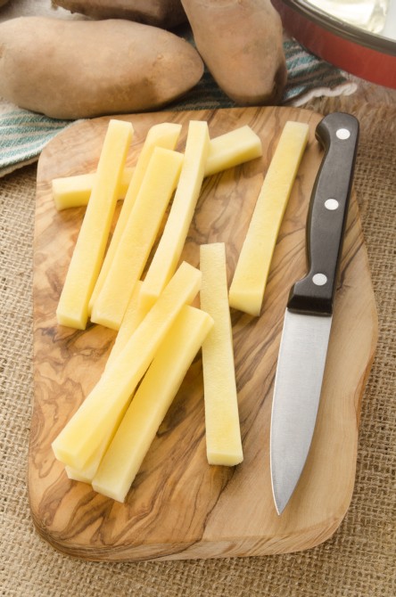 home made french fries and a kitchen knife on wooden board home made french fries and a kitchen knife on wooden board