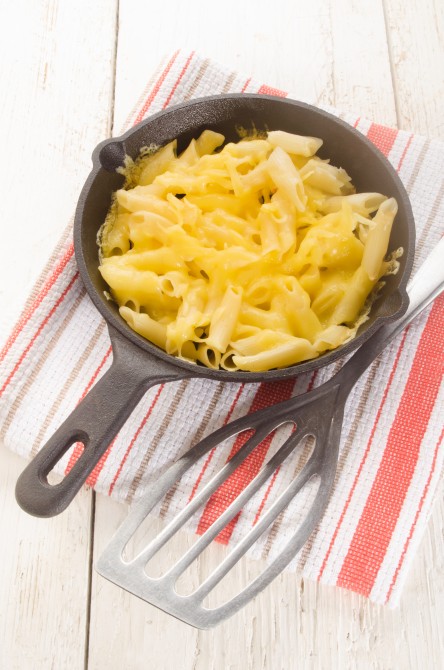 pasta with melted cheese in a cast iron pan