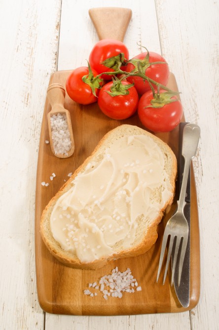 lard bread with coarse salt and tomatoes on wooden board lard bread with coarse salt and tomatoes on wooden board