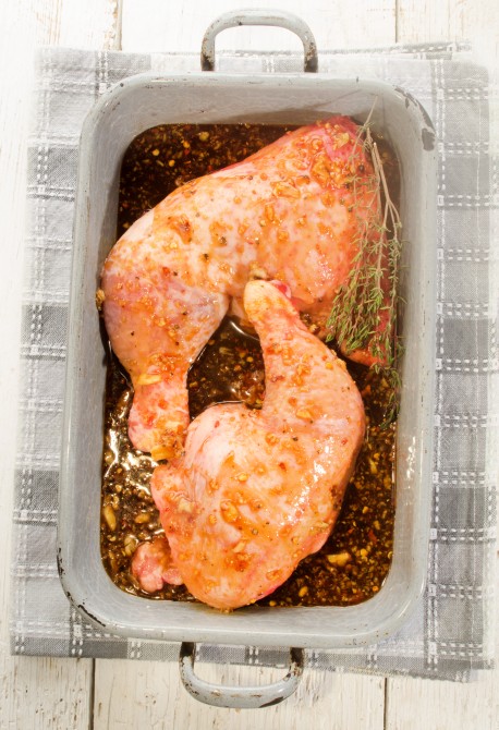 raw chicken leg with a home made marinade and thyme raw chicken leg with a home made marinade and thyme