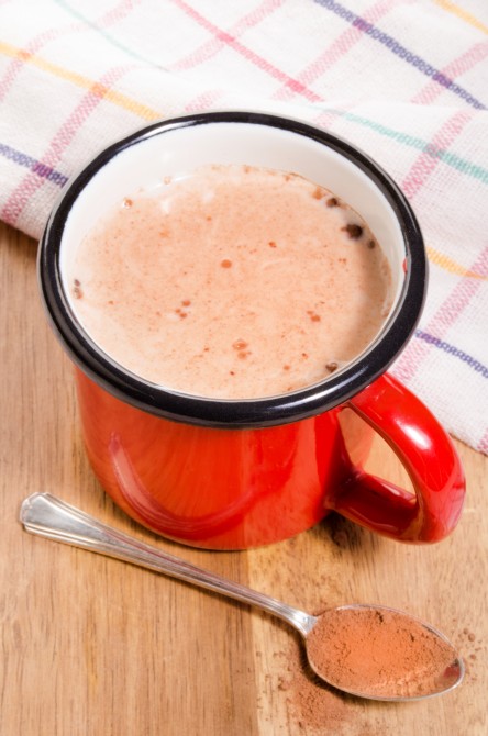 red enamel mug with cold milk and cocoa