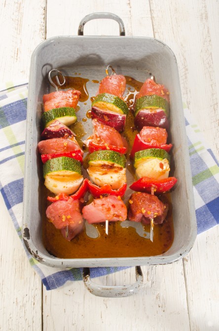 marinated hungarian pork and vegetable skewers in a rustic roasting tray