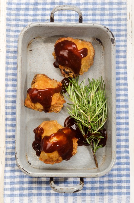 chicken thigh with barbecue sauce in rustic grey roasting pan