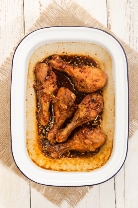chicken drumstick with a marinade consisting of honey, soy sauce, pepper and chilli flakes in blue and white enamel bowl chicken drumstick with a marinade consisting of honey, soy sauce, pepper and chilli flakes in blue and white enamel bowl