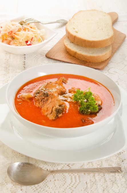 hungarian carp soup with sour cream in a white soup plate hungarian carp soup with sour cream in a white soup plate