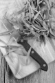 fresh tarragon and kitchen knife on wooden board