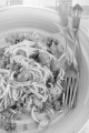 spaghetti with tuna, olive, caper and basil on a plate