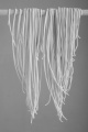 homemade spaghetti hung on a wooden stick to dry