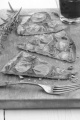 thin flat bread pizza with potato and rosemary on wooden board