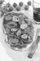 flat bread pizza with tomato, onion and basil on brown paper 