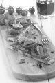 flat bread pizza with tomato, onion and basil on a wooden board