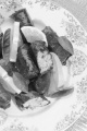 stuffed grape leaves, lemon and basil on a plate