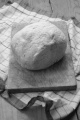 white bread on wooden board with kitchen towel
