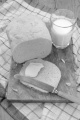 bread and a slice with butter and glass of cold milk