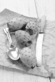 cactus fig with knife and spoon on brown paper
