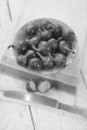 green cherry peppers in a bowl with knife and kitchen towel