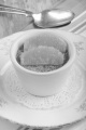creme brulee with orange in a white bowl