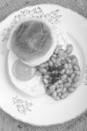 irish breakfast muffing with fried egg, parsley and baked beans on a plate