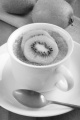creme brulee with kiwi slices in a cup