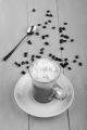 irish coffee in a glass mug with spoon and coffee bean