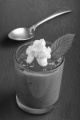 chocolate mascarpone dessert with orange mousse and whipped cream in a shot glass on slate