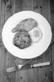 irish raisin boxty with grilled bacon and fried egg on a plate