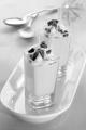 strawberry cream dessert with broken chocolate and whipped cream in a shot glass spoons in the background